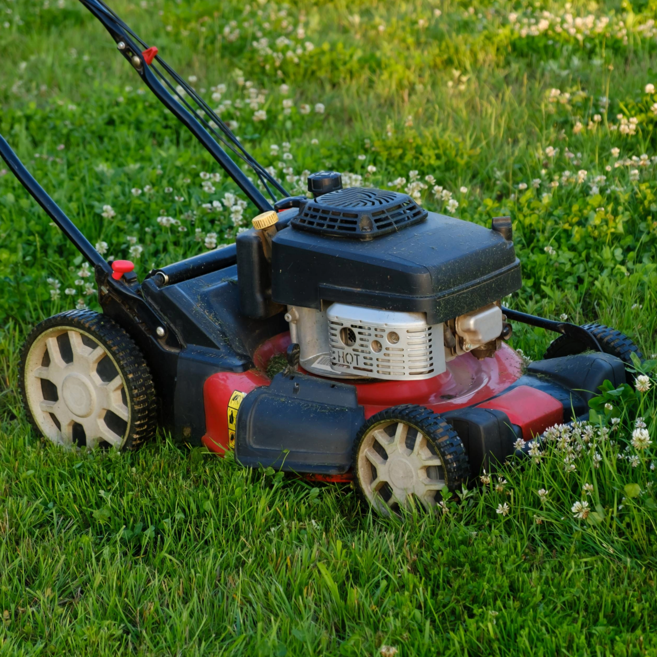 Lawn mower on green grass background